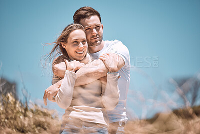 Buy stock photo In love, hugging and relaxing young couple happy, smiling on an outdoors vacation getaway. Romantic couple relax outside together embracing and loving romance, happiness and the sun on a summer day 