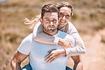 Piggyback, trendy and happy young couple smiling, bonding  and enjoying outdoors in summer or spring. In love, dating and in relationship partners playing and having fun on a romantic date together.
