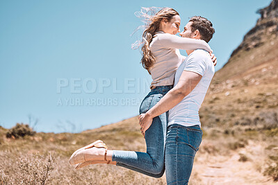 Buy stock photo Happy, loving and young couple embracing each other on a getaway in nature with copyspace. Girlfriend and boyfriend on a romantic summer vacation. Cheerful, smiling and caucasian partners hugging.