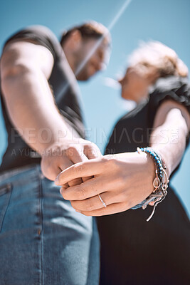 Buy stock photo Engaged couple celebrating romantic marriage proposal with engagement ring on hand from below outside. Love, bonding and romance for special occasion, devotion and commitment in relationship together