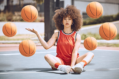 Female basketball player sitting with balls in the air on a court, learning fitness training and doing sport exercise and workout outside. Portrait of a black woman playing game and looking confident