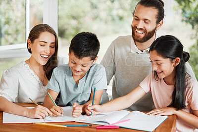 Buy stock photo Learning, education and homework with a family writing, drawing and studying together on a table at home. Parents and children bonding and spending time together while feeling happy and carefree