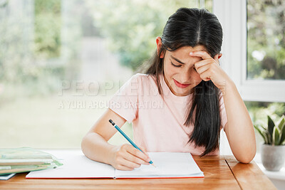 Buy stock photo Stressed, frustrated and unhappy girl writing homework with a difficult task alone at home. Tired school child studying for a hard exam. Upset student learning with homeschooling education.