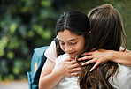 Happy, smiling and young daughter hugging her mother, greeting and giving embrace before school in the morning. Loving, caring and kind parent embracing, holding and showing affection to little girl