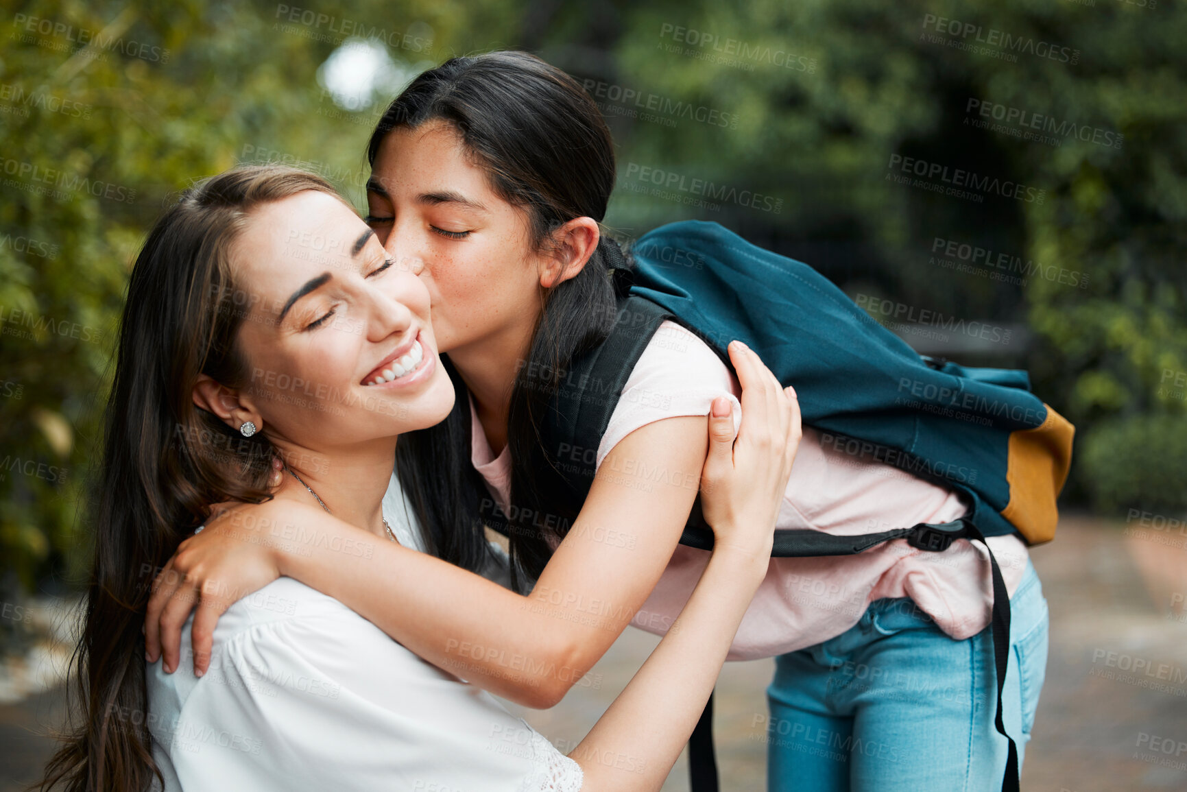 Buy stock photo Daughter, hugging and giving a kiss to her mom before going into school. Happy parent has strong relationship and cute bond with her child. Young girl shows love, affection and care for her mother.