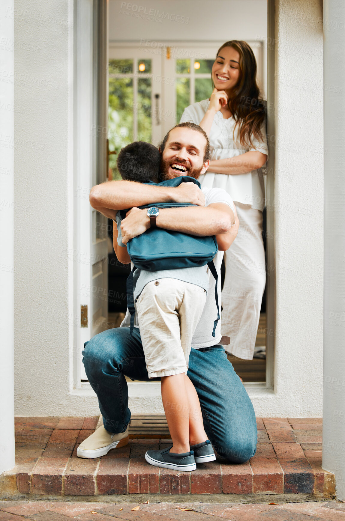 Buy stock photo Loving dad hug and embrace son, love from father to son or parents saying goodbye to child on front porch at home. Happy family greeting little boy with mother standing in doorway or house entrance.