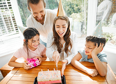 Buy stock photo Birthday, cake and celebration with a family celebrating a mother on a special day. Cutting the dessert, having a party and spending time together. Fun, laughter and enjoyment with mom, dad and kids