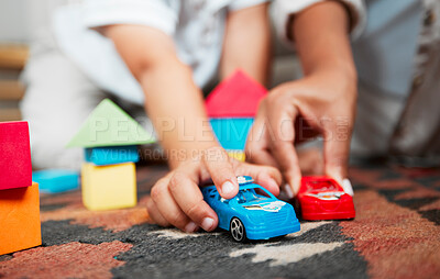 Buy stock photo Closeup hands playing with fun toys, cars and building blocks in a home living room. Parent bonding, having fun and enjoying family time with a playful, small and little child during childhood fun