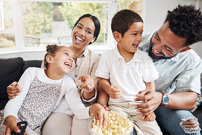 Buy stock photo Family watching tv or a movie, having fun and eating popcorn together at home. Love and laughter with affectionate parents and happy children smiling, enjoying the weekend and feeling carefree