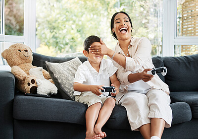 Buy stock photo Mother and son playing video games, having fun and enjoying quality time together. Cheerful, bonding and carefree child and parent using a gaming console or interactive modern technology
