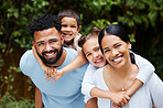 Happy, carefree and fun family playing, bonding and enjoying a day in a nature park together on the weekend in summer. Portrait of the faces of cheerful, caring and loving children hugging parents