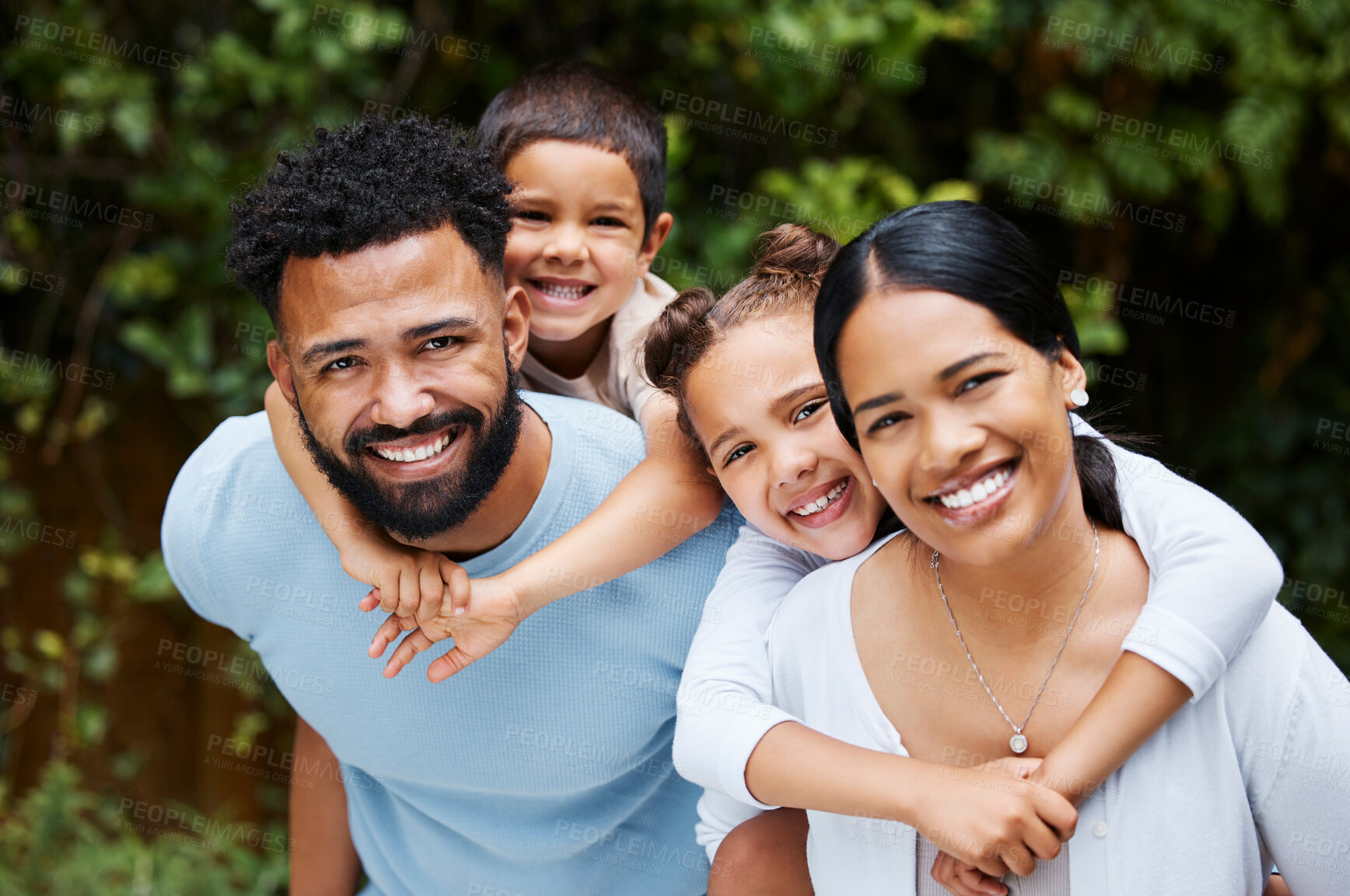 Buy stock photo Happy, carefree and fun family playing, bonding and enjoying a day in a nature park together on the weekend in summer. Portrait of the faces of cheerful, caring and loving children hugging parents
