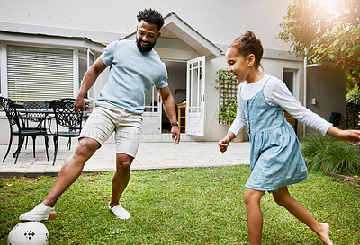 Buy stock photo Playing, bonding and having fun in a garden with a smiling father and happy little girl outside. Dad teaching football, learning and showing his daughter how to kick a soccer ball outdoors together 