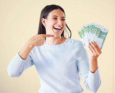 Buy stock photo Money, investment growth and finance success of a happy, excited and smiling woman pointing at cash reward. Lucky and happy female showing her growing financial wealth, savings or bank loan payout