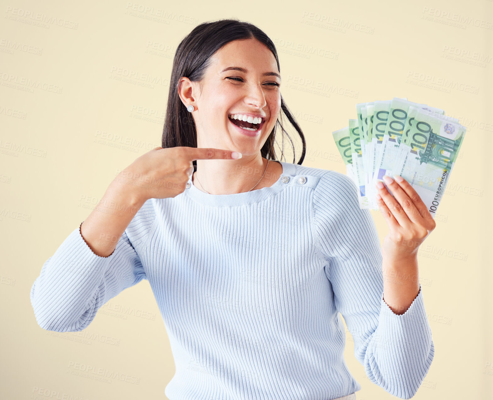 Buy stock photo Money, investment growth and finance success of a happy, excited and smiling woman pointing at cash reward. Lucky and happy female showing her growing financial wealth, savings or bank loan payout