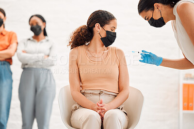 Buy stock photo A covid vaccine of a young woman getting vaccinated for work in the office. Young wearing a mask female getting an injection or treatment to prevent the spread of coronavirus at the workplace