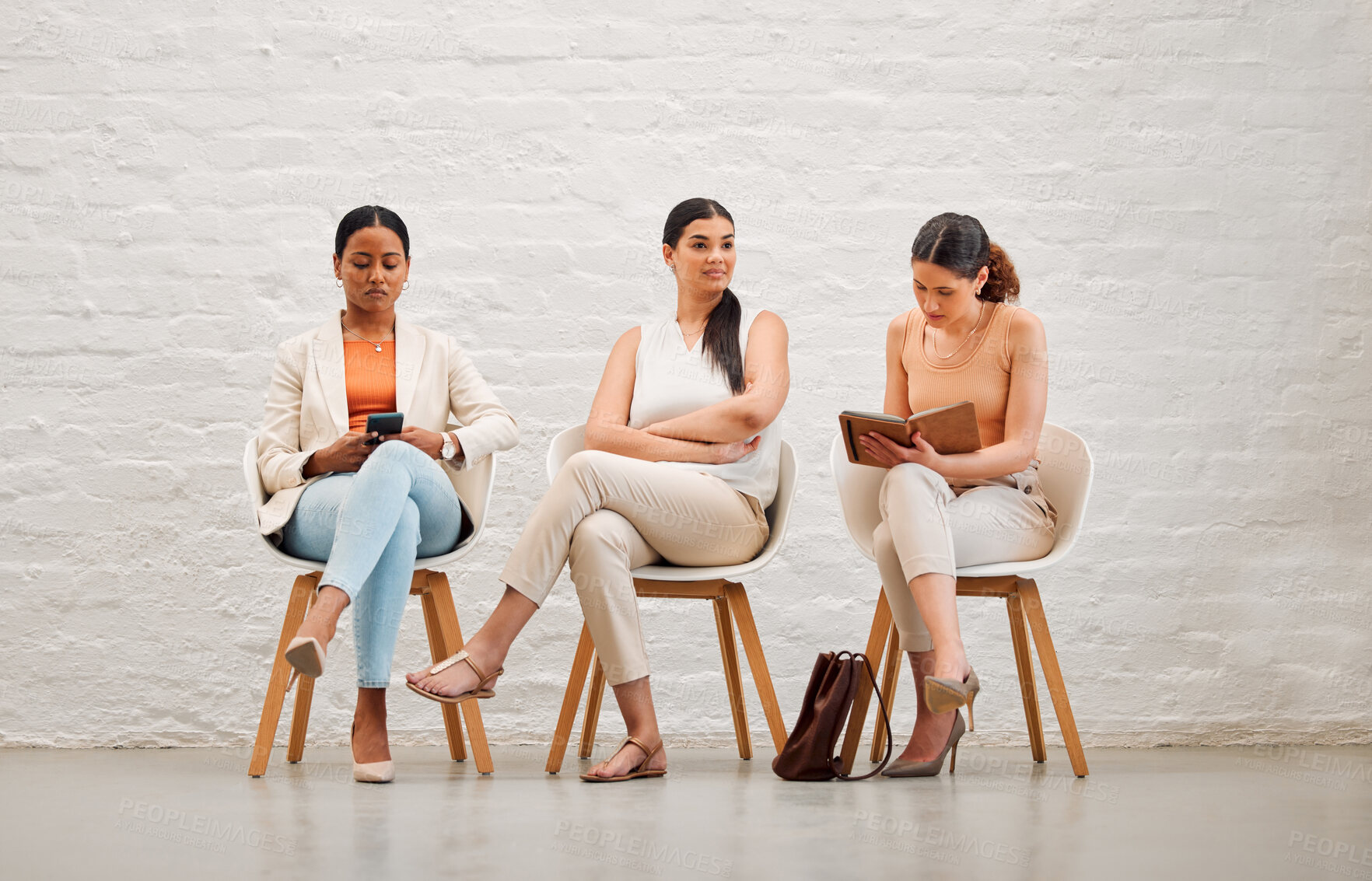 Buy stock photo Employment, hiring and recruitment with business women waiting for an interview with human resources and sitting on chairs. Young female shortlist candidates doing research and preparing for meeting
