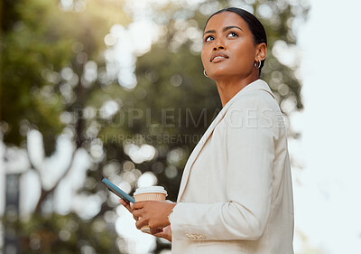 Buy stock photo Thinking, motivation and ambition with a young business woman looking to the future with a vision and mission for growth. Female entrepreneur typing on a phone and drinking coffee outside from below