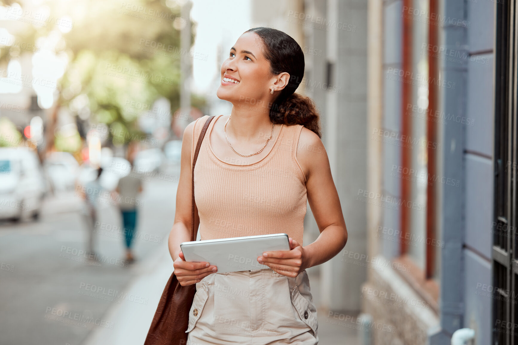 Buy stock photo Vision, ambitious and inspired creative woman walking in an urban city holding a digital tablet. Female designer exploring, visiting and enjoying a sightseeing in a town outdoors for inspiration.