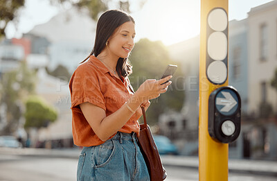 Buy stock photo Texting on a phone, browsing social media and waiting for public transport and commuting in the city. Young female tourist enjoying travel and Looking online for places to see and visit on holiday