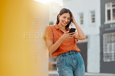 Buy stock photo Woman texting, browsing and scrolling on phone while chatting on social media, waiting for taxi and commuting in an urban city. Happy, trendy and smiling female tourist reading online notification