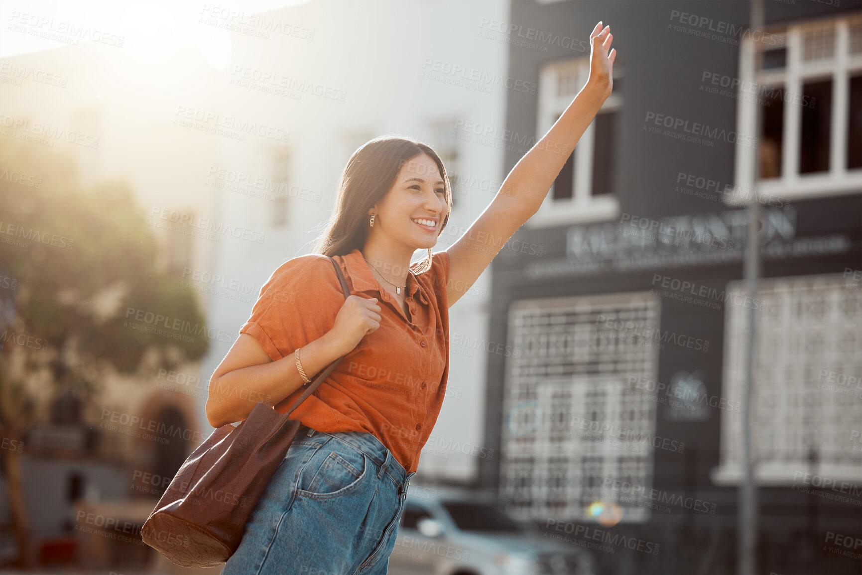 Buy stock photo Waving for a taxi, waiting in the street for a ride outside.  Smiling urban woman wants to travel downtown for work or fun with a cab. Lady gestures for transportation with confident arm raised.