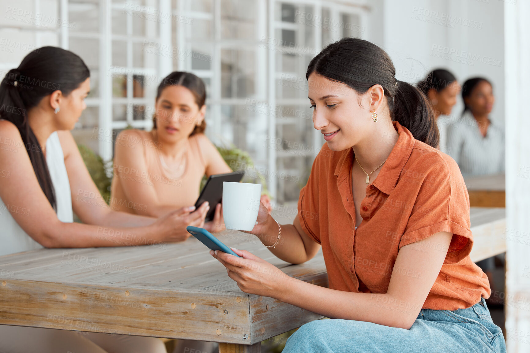 Buy stock photo Businesswoman, designer or worker on her phone texting, reading and replying to sms with smile while drinking coffee at work. Professional female relaxing, searching and browsing during her lunch.