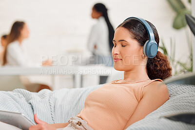 Buy stock photo Rest, relaxation and break with a modern and creative design professional listening to music with wireless headphones on a beanbag chair. Young business woman resting in her office for mental health