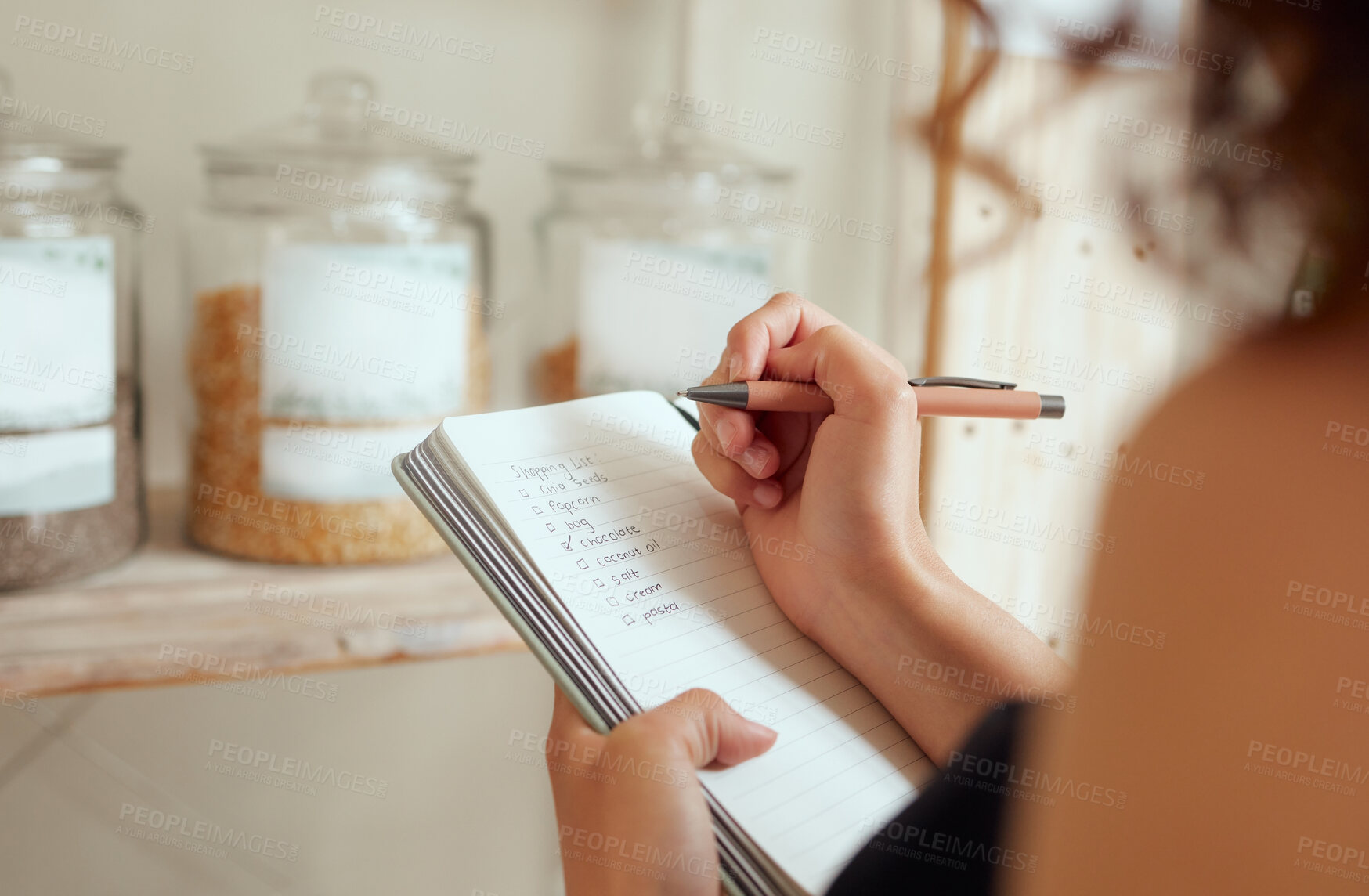 Buy stock photo Budget planning, making shopping list and managing household expenses to save money. Financial accountability at home. Woman making shopping list for groceries on a notebook to plan a meal for dinner