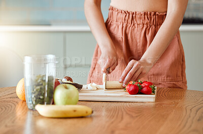 Buy stock photo Woman making healthy smoothie for energy, nutrition and wellness with fresh organic fruit being cut, sliced and prepared. Delicious detox drink, wholesome diet and cleanse with vitamins and nutrients
