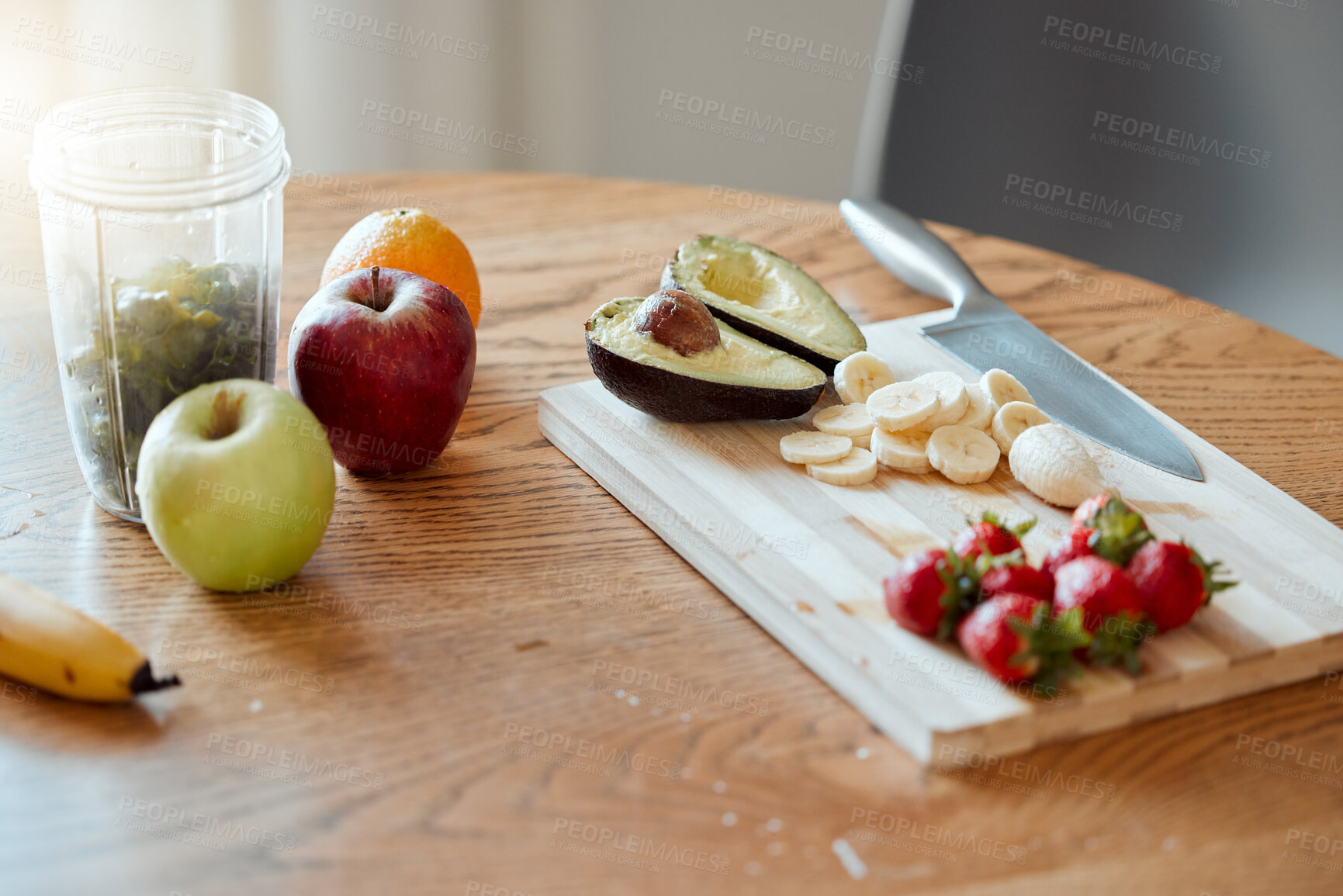 Buy stock photo Cooking, preparing and making fruit smoothie, drink and salad in home kitchen for healthy breakfast, meal and snack. Closeup of apples, strawberries and avocado with banana for vitamins and nutrition