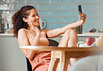 Woman waving, talking and greeting on video call and online phone chat with webcam at home. Smiling, happy and relaxed female having conversation while connecting with virtual contact on the internet