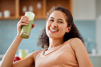 Green smoothie, drink and healthy juice for weight loss, detox or breakfast diet in home living room. Portrait of smiling, happy woman drinking fruit or vegetarian beverage with vitamins or nutrition