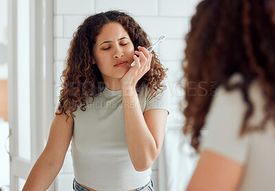 Buy stock photo Toothache, oral pain and dental sensitivity for a woman brushing her teeth in the morning. African American female suffering with a painful, hurting or inflammation in her mouth in the bathroom