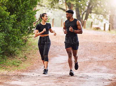 Buy stock photo Fitness, exercise and happy couple out running or jogging on a forest trail or park outdoors. Sporty and smiling man and woman staying active and fit while exercising and bonding during a workout