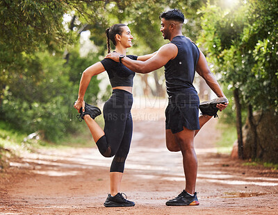 Buy stock photo Young fit couple exercising outdoors together, bonding while stretching and preparing for a cardio workout. Athletic girlfriend and boyfriend being affectionate while training and staying healthy