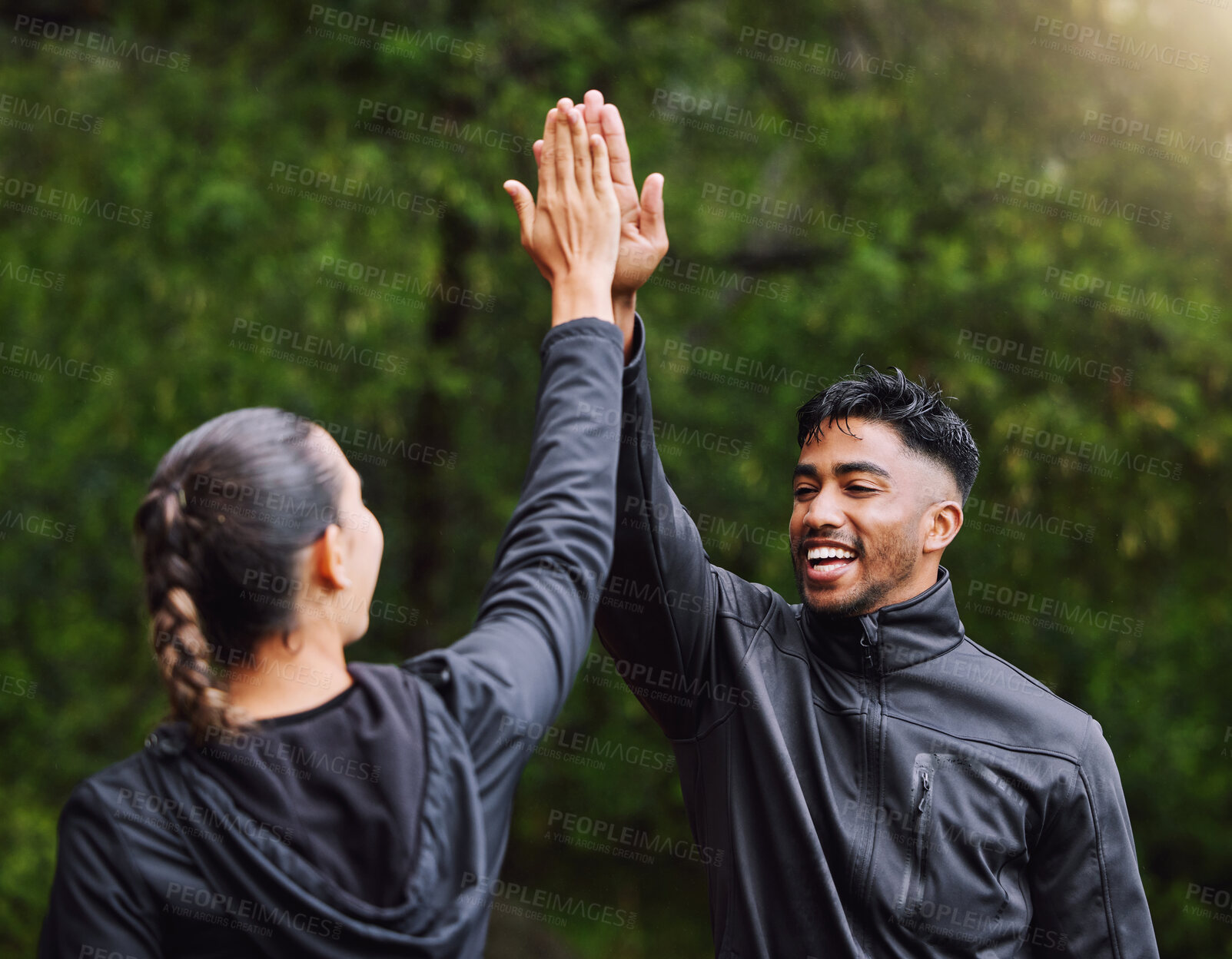 Buy stock photo Active, fit and sporty athletes doing a high five to celebrate  and congratulate on fitness goals. Healthy, happy and exercising couple motivated after training, getting cardio workout outside