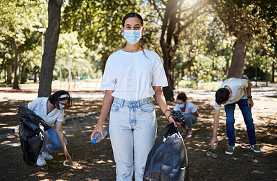Buy stock photo Covid, face mask and volunteer worker cleaning park, doing community service and helping pick up trash and plastic bottles. Support team of activists recycling, working together to end pollution
