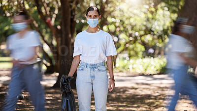 Buy stock photo Female wearing covid mask cleaning the park for a clean, hygiene and safe green outdoor environment. Community service, volunteers or activist workers with rubbish, trash and garbage in a plastic bag