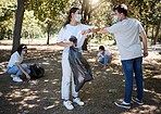 Covid, cleaning and volunteers wearing masks while cleaning a community park and saying thank you with a elbow gesture. Social disdancing between friends doing a cleanup outdoors during a pandemic