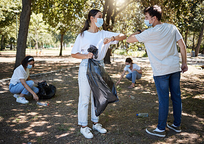 Buy stock photo Covid, cleaning and volunteers wearing masks while cleaning a community park and saying thank you with a elbow gesture. Social disdancing between friends doing a cleanup outdoors during a pandemic