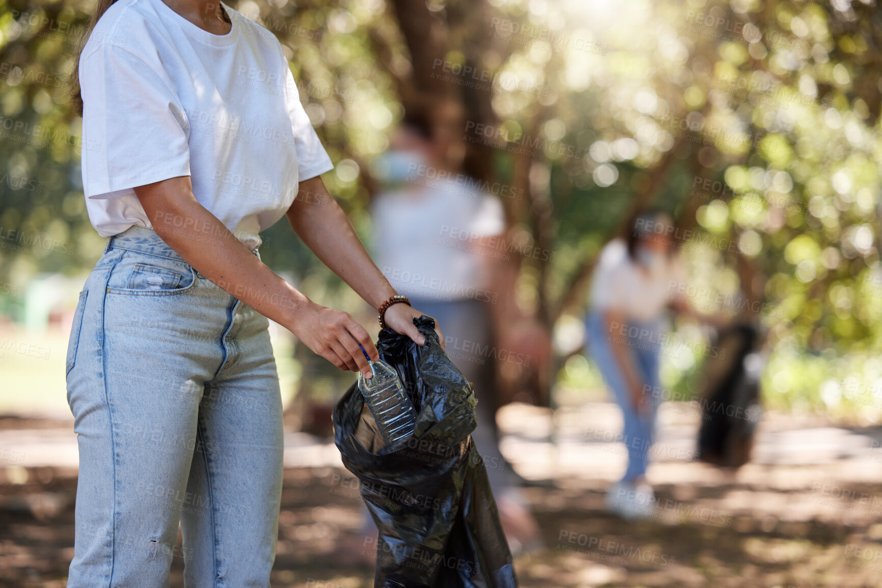 Buy stock photo Volunteer, recycle and reduce global waste by picking up litter, dirt and garbage outdoors in a park. Closeup of young female NGO activist cleaning pollution from the environment for sustainability