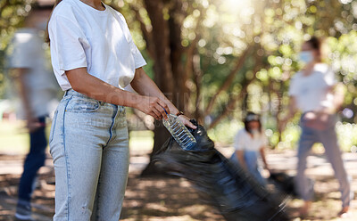 Buy stock photo Volunteers helping collect trash on community cleanup project outdoors, collecting plastic and waste to recycle. Woman cleaning environment, picking up dirt in street. People uniting to make a change