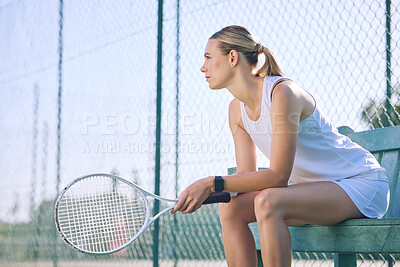 Buy stock photo Professional tennis player or sports woman with a racket gear or equipment sitting on a bench, taking a break or waiting for match to start. Active girl with a goal or vision for competition success