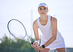 Tennis, sport and serious woman holding her racket and ready to play on court outside. Determined and sporty female playing in professional sports competition. Enjoying active hobby during free time