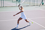 Fitness, balance and sport with athletic tennis player playing competitive match at a tennis court. Female athlete practicing her aim during a game. Lady enjoying active hobby she's passionate about