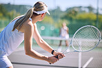 Active female tennis player back in motion holding racket, playing game match on outdoor sports court. Professional athlete training for sporty summer fun or fitness, health and wellness lifestyle.