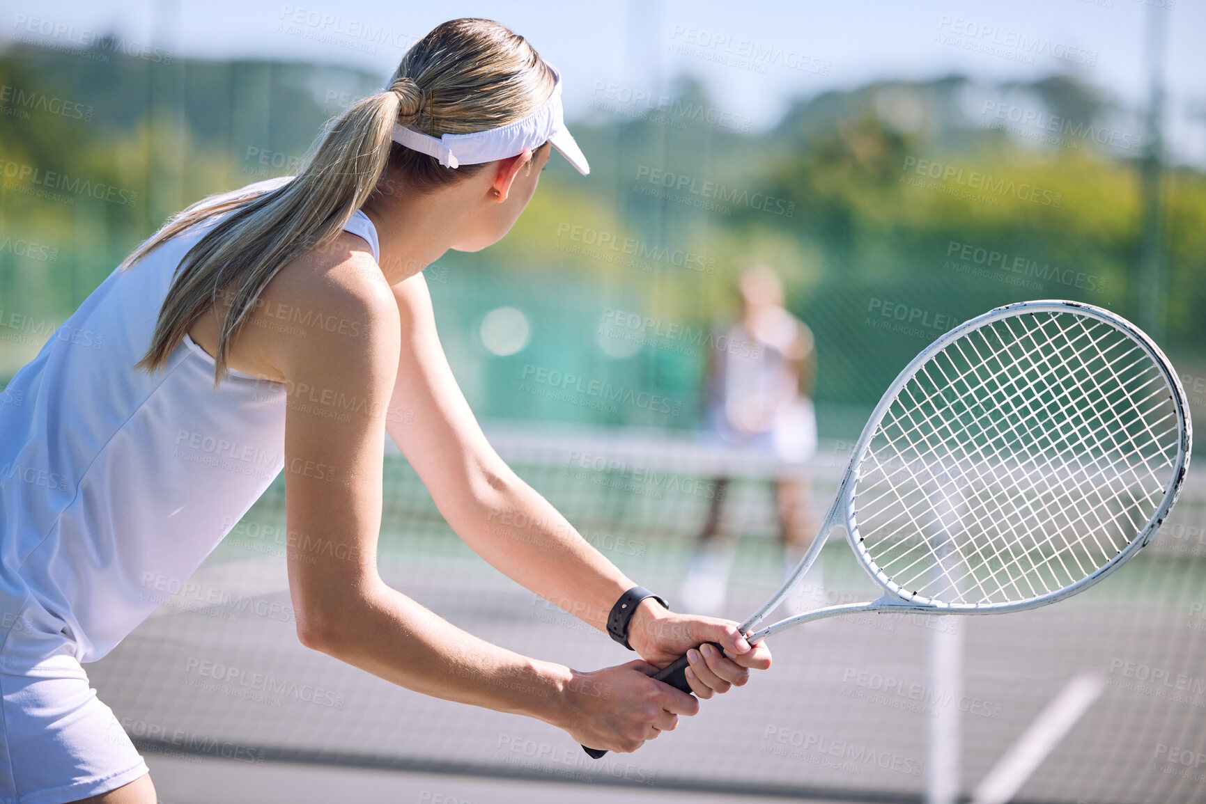 Buy stock photo Active female tennis player back in motion holding racket, playing game match on outdoor sports court. Professional athlete training for sporty summer fun or fitness, health and wellness lifestyle.