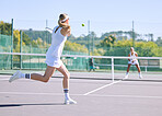 Fitness, balance and sport with athletic tennis players playing competitive match at a tennis court. Female athlete practicing her aim during a game. Lady enjoying active hobby she's passionate about