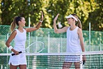 Active, tennis match players and fit female athletes high five hands after game on outdoor sports court. Happy, smiling women training exercise for wellness, healthy lifestyle and sporty, summer fun.